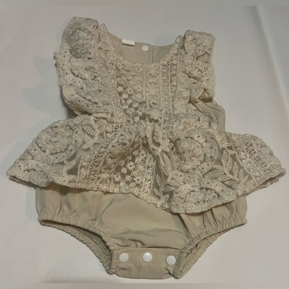 Baby’s lace bodysuit.